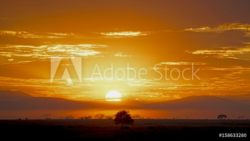 Picture of Sun rising through rain clouds in Serengeti Tanzania